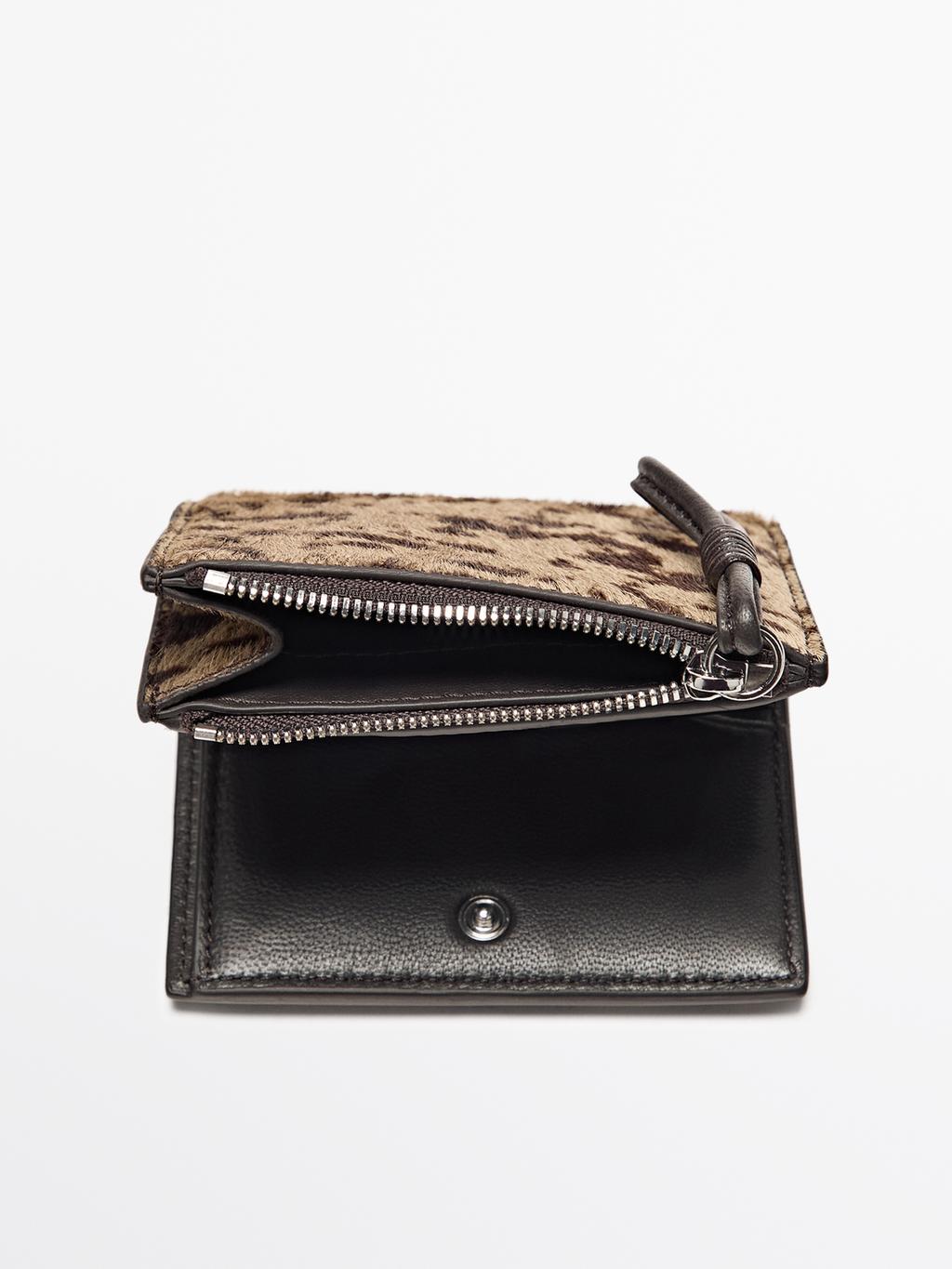 Animal print hair on leather wallet