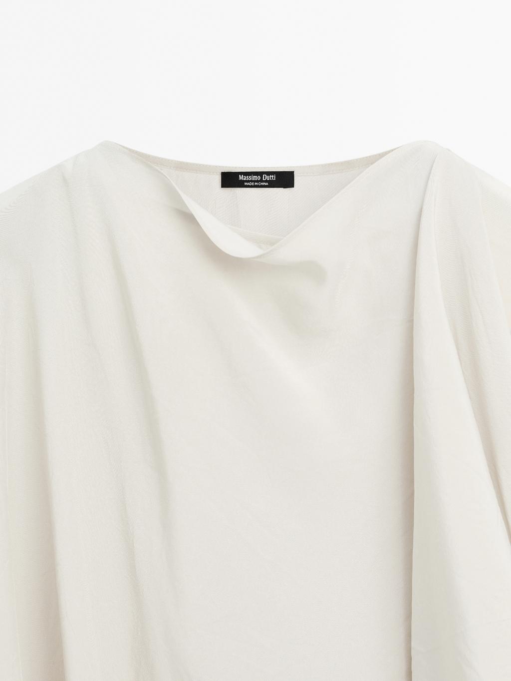 Short flowing cape with sleeve detail