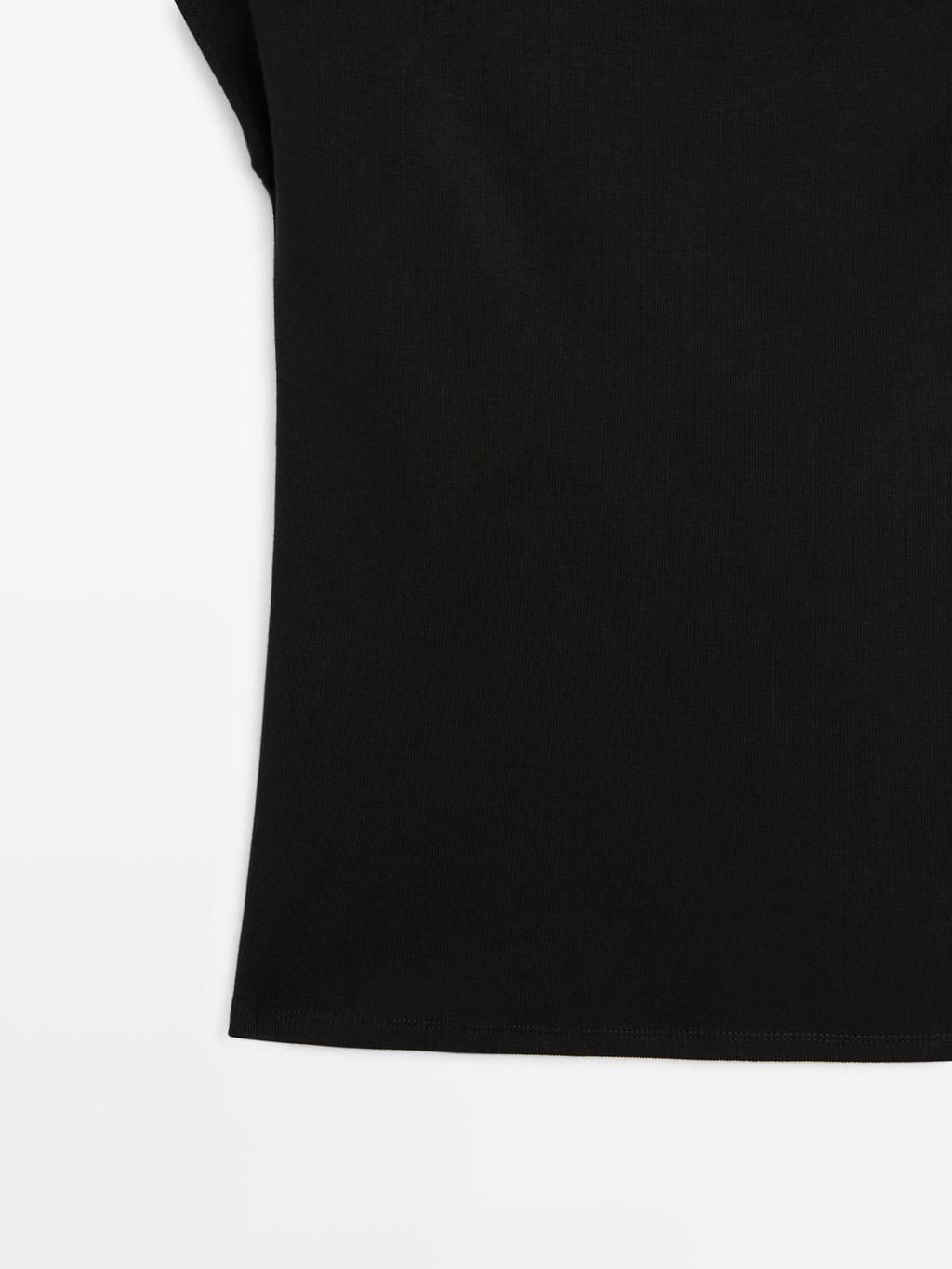 Sleeveless draped top with shoulder applique