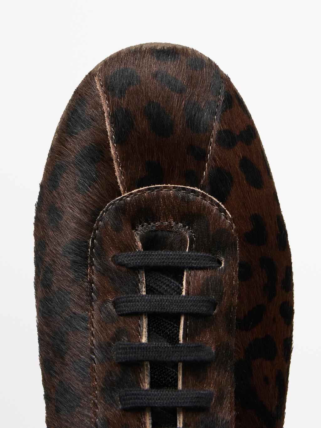 Leopard print hair on leather trainers